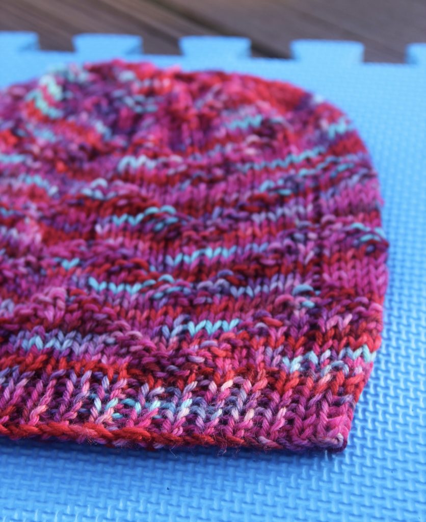 A hat is laid out to dry on a blocking mat.